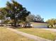 Ranch house with attached garage and large tree at 4131 Yorketowne Rd, Orlando, FL 32812