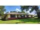 This single-story home has an attractive brick and siding exterior and a neatly manicured lawn at 4131 Yorketowne Rd, Orlando, FL 32812