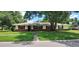 Charming single-story home featuring a brick facade, red shutters, and a well-maintained front lawn at 4131 Yorketowne Rd, Orlando, FL 32812