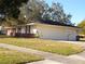 Inviting home exterior with manicured lawn and attached garage, offering a welcoming curb appeal at 4131 Yorketowne Rd, Orlando, FL 32812