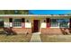 Welcoming front entrance with red door, red shutters, brick facade, and updated lighting at 4131 Yorketowne Rd, Orlando, FL 32812