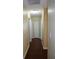 Hallway with wood floors, neutral walls, and doors leading to other rooms at 4131 Yorketowne Rd, Orlando, FL 32812