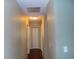 Long hallway with doors to bedrooms and closets at 4131 Yorketowne Rd, Orlando, FL 32812