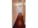 Hallway with a hardwood floor and multiple doors at 4131 Yorketowne Rd, Orlando, FL 32812