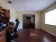 Home office features built-in wood desk and hardwood floors at 4131 Yorketowne Rd, Orlando, FL 32812