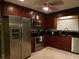 Modern kitchen with stainless steel appliances and dark wood cabinets at 4131 Yorketowne Rd, Orlando, FL 32812