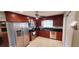 Well-lit kitchen featuring stainless steel appliances and dark wood cabinets with granite countertops at 4131 Yorketowne Rd, Orlando, FL 32812