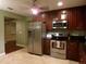 Modern kitchen with stainless steel appliances and dark wood cabinets at 4131 Yorketowne Rd, Orlando, FL 32812