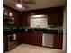 Modern kitchen with stainless steel appliances and dark wood cabinets at 4131 Yorketowne Rd, Orlando, FL 32812