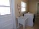 Well-lit laundry area with a utility sink and modern washer and dryer units at 4131 Yorketowne Rd, Orlando, FL 32812