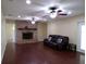 Living room with fireplace, hardwood floors, and ceiling fans; perfect for relaxation at 4131 Yorketowne Rd, Orlando, FL 32812