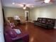 Living room with hardwood floors, leather furniture and two ceiling fans at 4131 Yorketowne Rd, Orlando, FL 32812