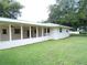 A screened-in patio featuring ceiling fans, offering an ideal space for outdoor relaxation and entertaining at 4131 Yorketowne Rd, Orlando, FL 32812