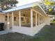 View of the home's screened porch with ceiling fans at 4131 Yorketowne Rd, Orlando, FL 32812