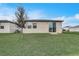 House backyard with grassy lawn and sliding glass door at 4451 Rapallo Ave, Winter Haven, FL 33884