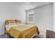 Bright bedroom with mustard yellow bedding and a window at 4451 Rapallo Ave, Winter Haven, FL 33884