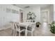 Bright dining room with white table and gray chairs at 4451 Rapallo Ave, Winter Haven, FL 33884