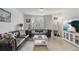 Living room with a brown leather sofa and a large TV at 4451 Rapallo Ave, Winter Haven, FL 33884