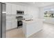 Bright kitchen with stainless steel appliances, center island, and modern white cabinetry at 507 Silver Palm Dr, Haines City, FL 33844