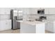 Modern kitchen with stainless steel refrigerator and a center island with a sink at 507 Silver Palm Dr, Haines City, FL 33844