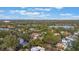 Aerial view of a house in a tree-lined neighborhood near a lake at 512 E Gore St, Orlando, FL 32806