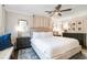 Bright main bedroom with a king-size bed and seating area at 512 E Gore St, Orlando, FL 32806