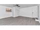 Spacious bedroom with gray flooring, ceiling fan, and white closet at 520 Sw 38Th St, Ocala, FL 34471