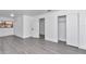 Bedroom featuring grey laminate flooring, white trim, and an entrance to closet space at 520 Sw 38Th St, Ocala, FL 34471