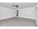 Bright bedroom with gray flooring, ceiling fan, and white walls at 520 Sw 38Th St, Ocala, FL 34471