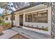 Welcoming front porch with brick planter and black wrought iron accents at 520 Sw 38Th St, Ocala, FL 34471