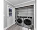 Convenient laundry area with washer, dryer, and shelving at 520 Sw 38Th St, Ocala, FL 34471