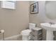 Clean and modern bathroom with pedestal sink and toilet at 5317 Jubiloso Dr, St Cloud, FL 34771