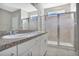 Modern bathroom with double vanity, granite countertop and glass shower at 5317 Jubiloso Dr, St Cloud, FL 34771