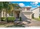 Two-story house with tan siding, brown door, and a two-car garage at 5317 Jubiloso Dr, St Cloud, FL 34771