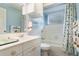 Clean bathroom, white vanity, bathtub, shower, and nautical decor at 8045 Happy Trl, Kissimmee, FL 34747