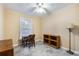 Bright bedroom featuring a desk, bookcase, and window at 8045 Happy Trl, Kissimmee, FL 34747