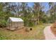 Small greenhouse and shed located in the backyard at 8045 Happy Trl, Kissimmee, FL 34747