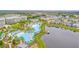 Aerial view of resort community with pool and lake at 8153 Surf St, Kissimmee, FL 34747