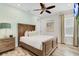 Bright bedroom with queen bed, nightstands and ceiling fan at 8153 Surf St, Kissimmee, FL 34747