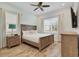 Light and airy bedroom with a queen-size bed, dresser, and ceiling fan at 8153 Surf St, Kissimmee, FL 34747