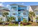 Two-story light blue house with balcony, shutters, and walkway at 8153 Surf St, Kissimmee, FL 34747