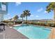 Relaxing pool area with lake view, spa, and patio furniture at 8153 Surf St, Kissimmee, FL 34747