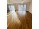 Bright living room with laminate floors and sliding doors at 8211 Sun Spring Cir # 42, Orlando, FL 32825