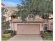 Attractive two-story home with a two-car garage and well-manicured landscaping at 8407 Riverdale Ln, Davenport, FL 33896