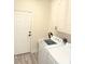 Laundry room with washer, dryer, and cabinets at 8407 Riverdale Ln, Davenport, FL 33896