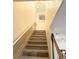 Stylish staircase featuring a chandelier and wood treads at 8407 Riverdale Ln, Davenport, FL 33896