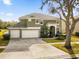 Two-story house with a large driveway and surrounding landscape at 8511 La Isla Dr, Kissimmee, FL 34747