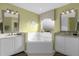 Bathroom with a corner soaking tub and and sinks at 8511 La Isla Dr, Kissimmee, FL 34747