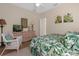 Bedroom with wicker chairs and leafy bedding at 8511 La Isla Dr, Kissimmee, FL 34747