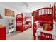 Bedroom with bunk beds, red decor, and Mickey Mouse theme at 8511 La Isla Dr, Kissimmee, FL 34747